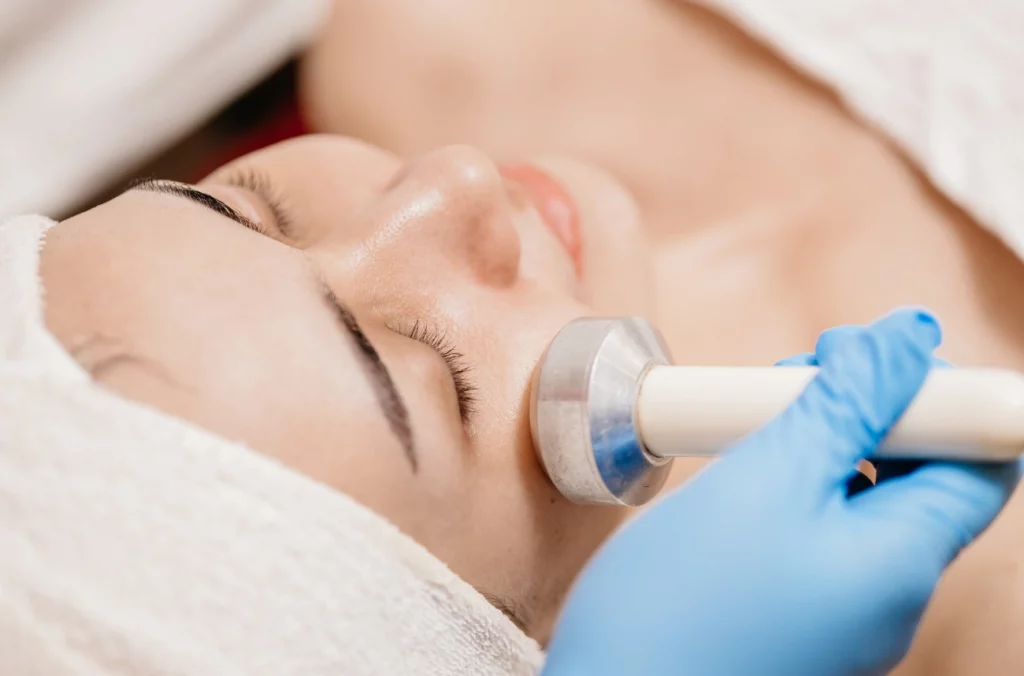 Provider performing skin tightening facial treatment