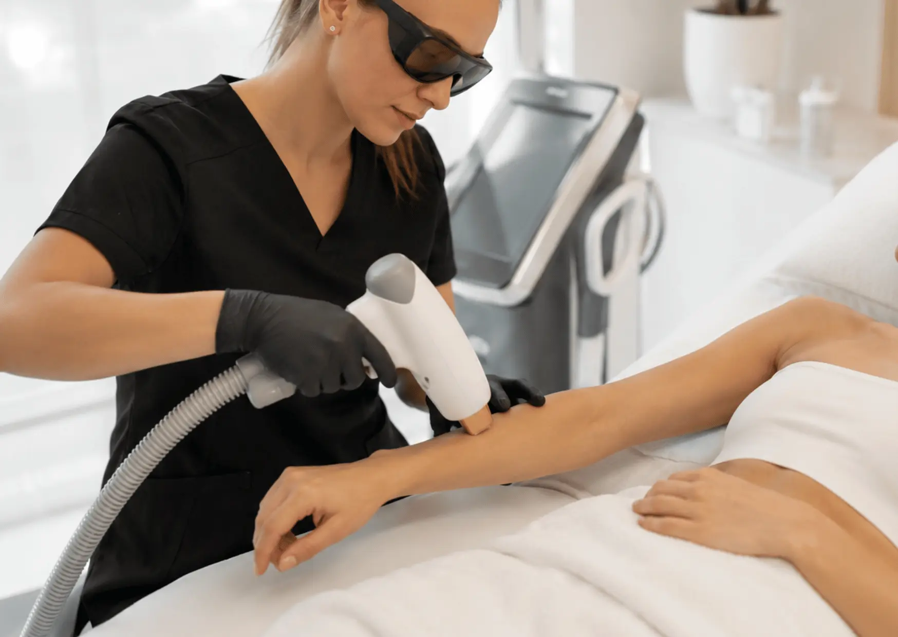 Laser hair removal treatment being performed on a client’s arm at Arizona Medlaser
