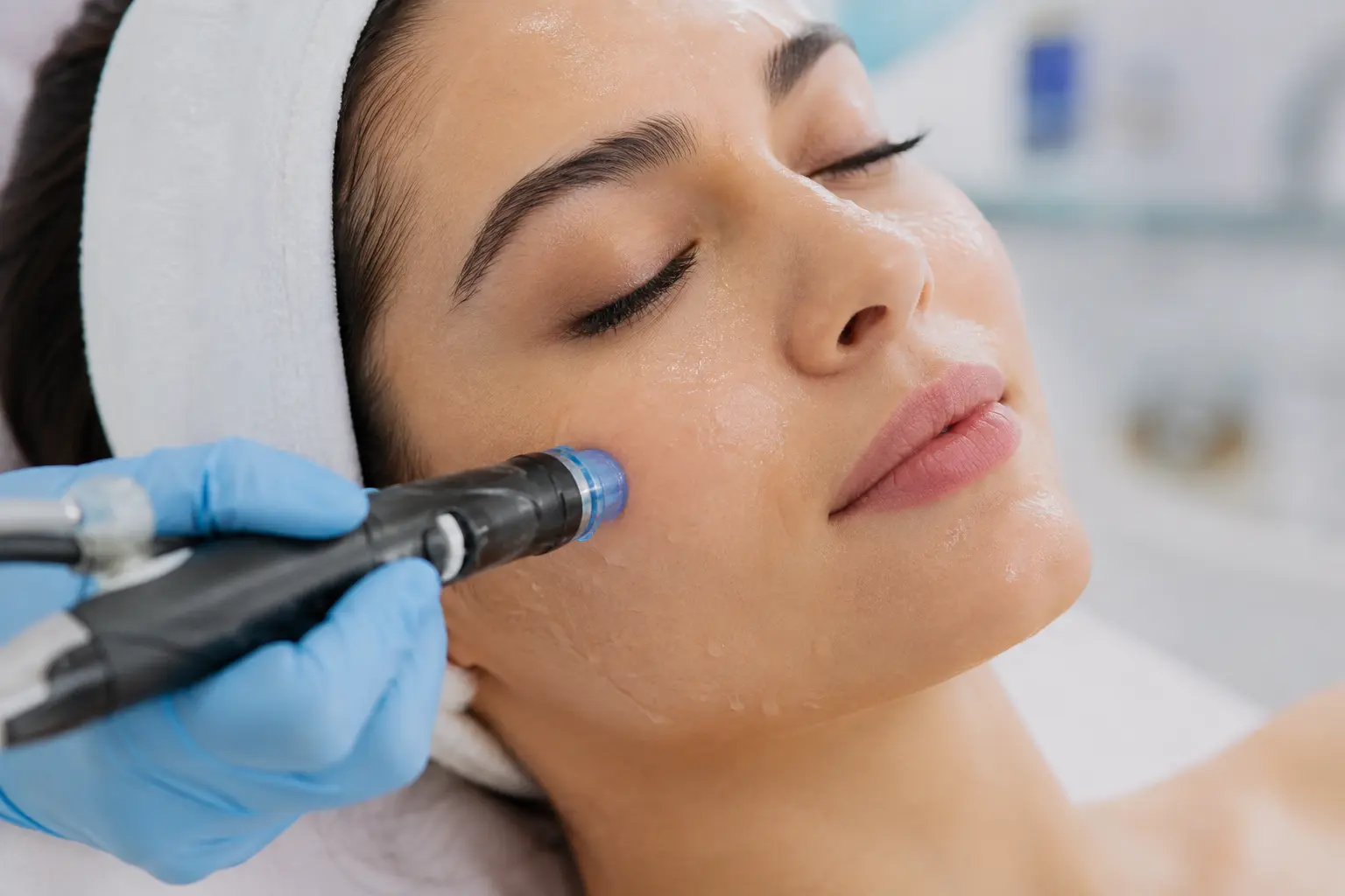 Close-up of a client receiving a Hydro Glow Facial wand treatment at Arizona Medlaser to cleanse and hydrate skin.